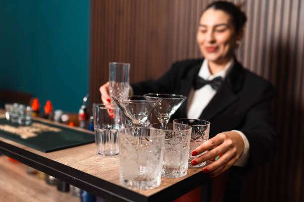 Bartender preparing elegant cocktail glasses, ready for drinks made with a Cocktail Shaker.
